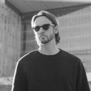 Matt Black looking in the distance, wearing sunglasses
